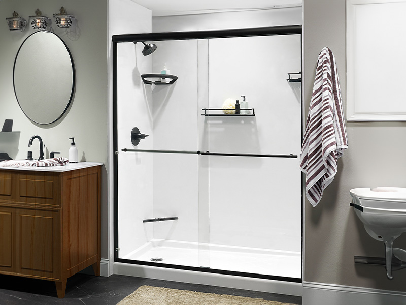 Walk-in shower with white walls and black fixtures