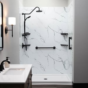 Modern walk-in shower with marble walls and black fixtures